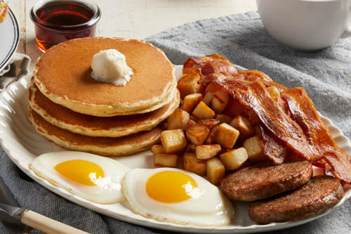 Garbage Omelet loaded with sausage, ham, bacon, and fresh vegetables